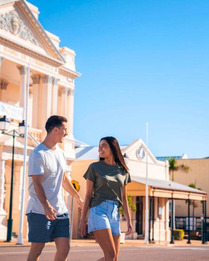A young couple walk through the town of Charters Towers, Townsville.