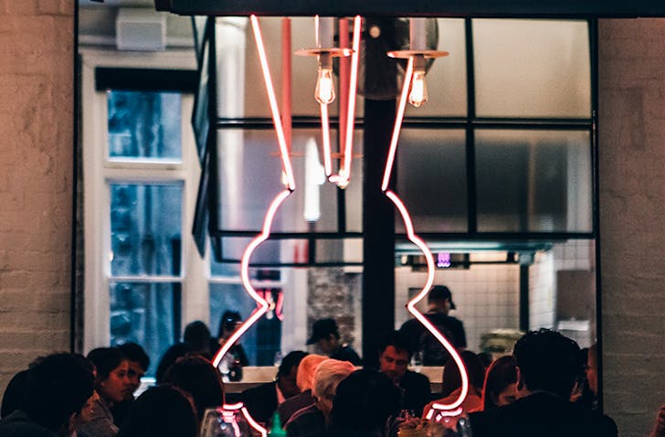 A big dining room filled with diners at a top best private dining rooms in Melbourne.