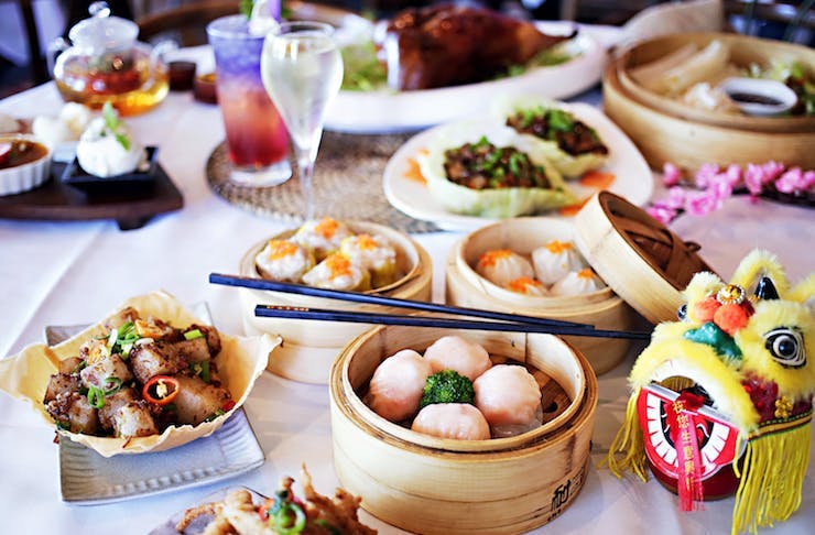 A table packed with delicious dumplings and other Chinese eats.