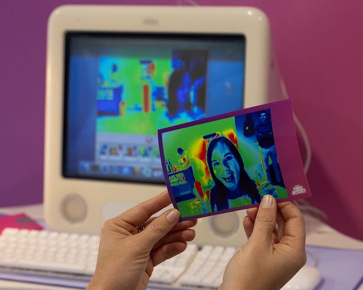 Someone holds a print-out of a selfie in an old skool aesthetic. 