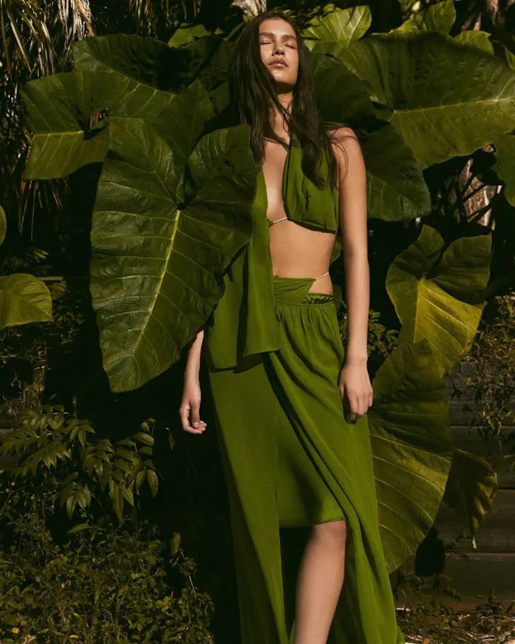 A model wears a green dress with a cutout from Christopher Esber one of the best Australian fashion labels