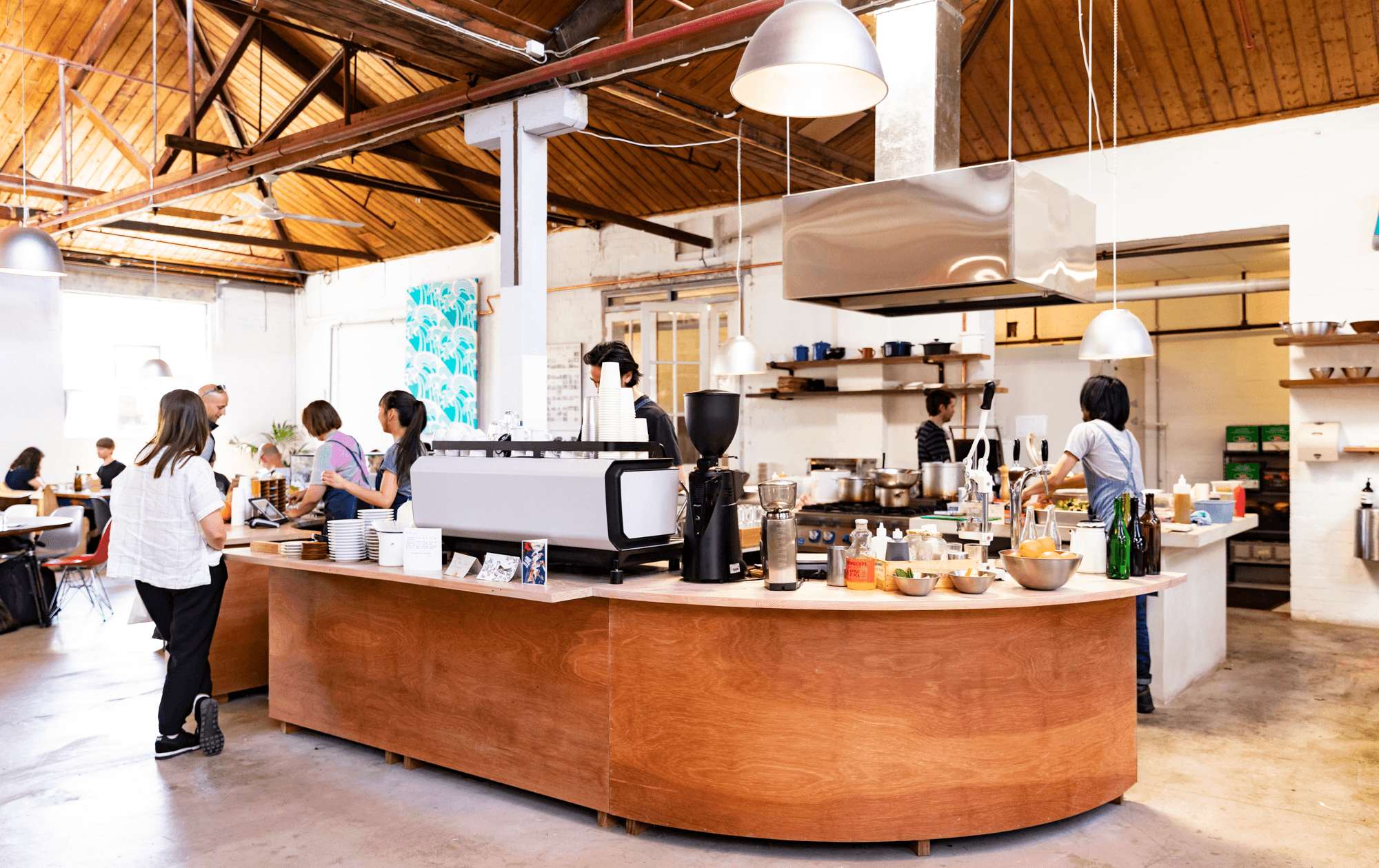 The inside of a best lunch melbourne cafe, with waiters and baristas. 