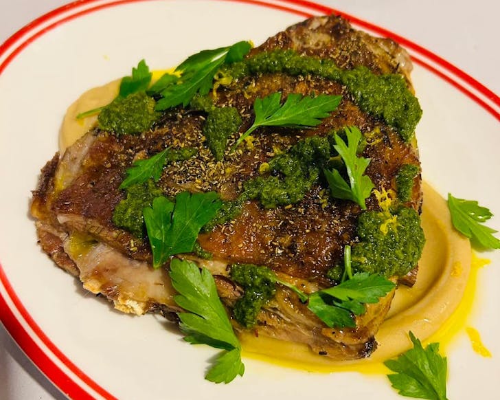 A triagular slab of a nondescript meaty Italian dish.