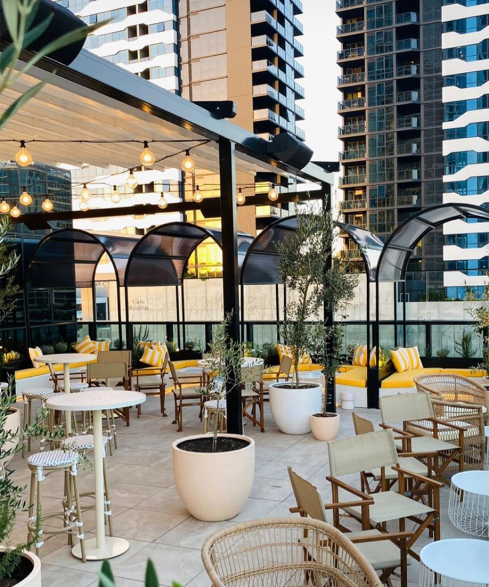 interior of Cielo's rooftop bar area, with yellow booths and euro style tables