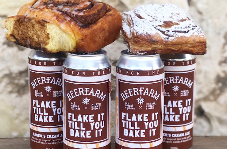 4 beer cans with cinnamon scroll and apple turnover on top
