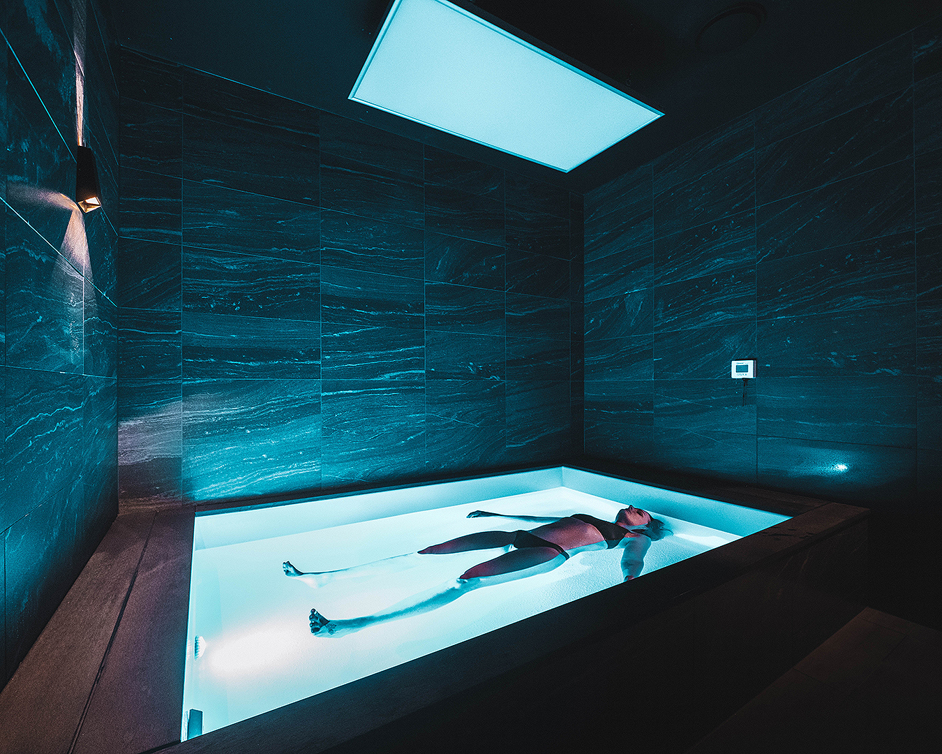 A person relaxes in a luxurious float room at City Cave.