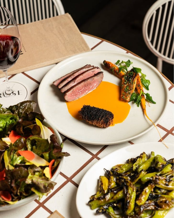 A euro style dish served with steak and fresh vegetable salads