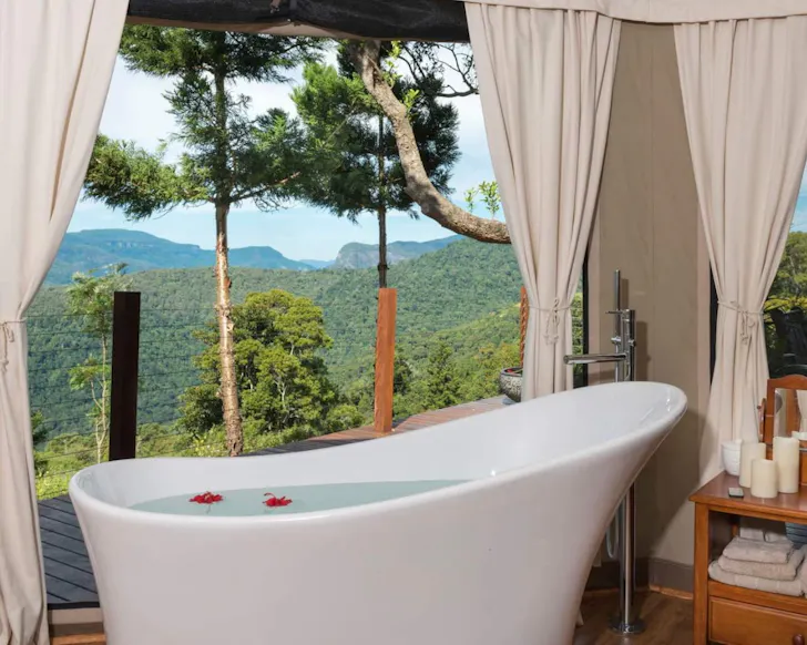 A view of a white outdoor bath with a great view at Clouds Safari Airbnb near Brisbane Queensland