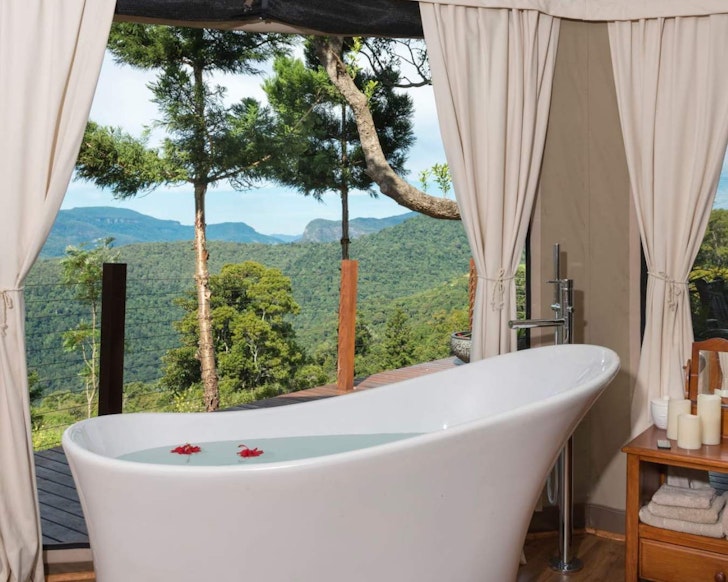 A view of a white outdoor bath with a great view at Clouds Safari Airbnb near Brisbane Queensland