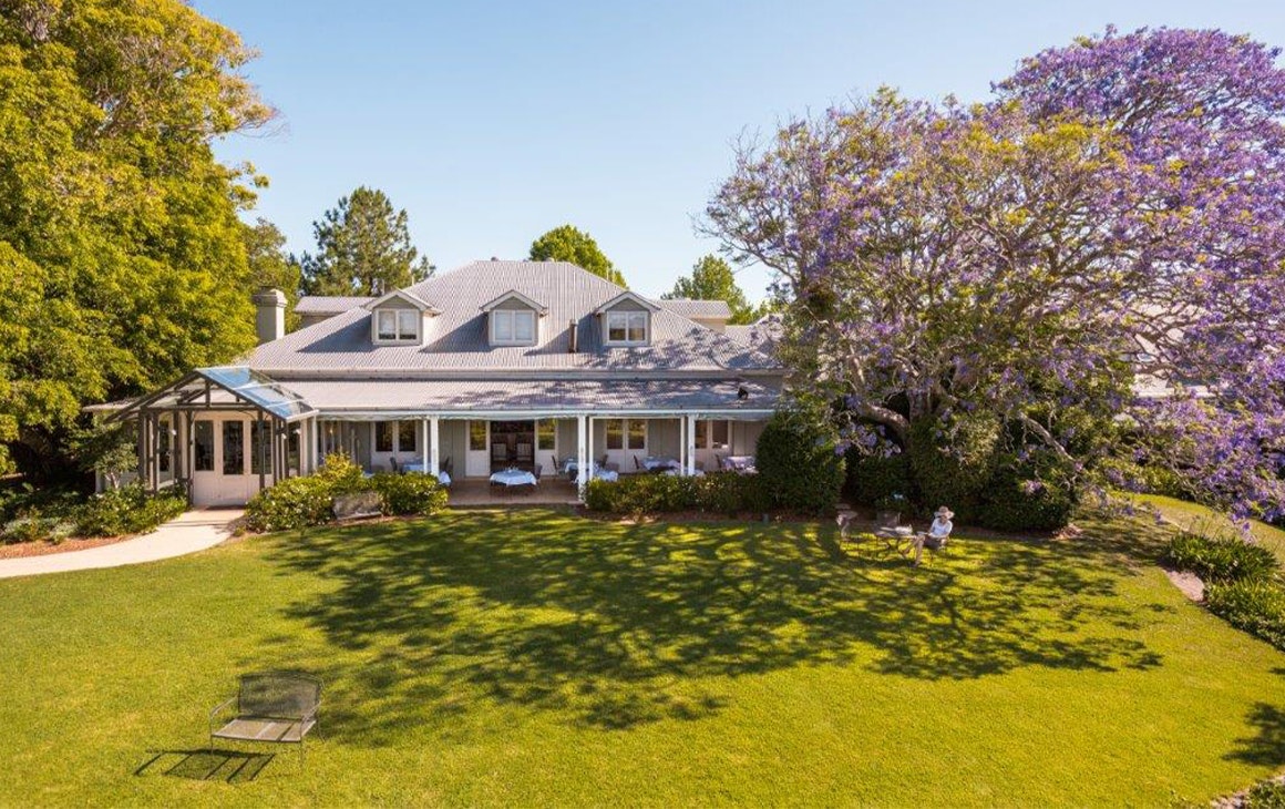 the main lodge surrounded by jacaranda trees