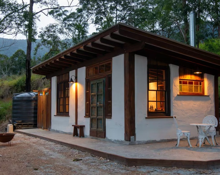 An exgterior view of the character-filled Cob Cabin one of the best tiny homes near South East Queensland