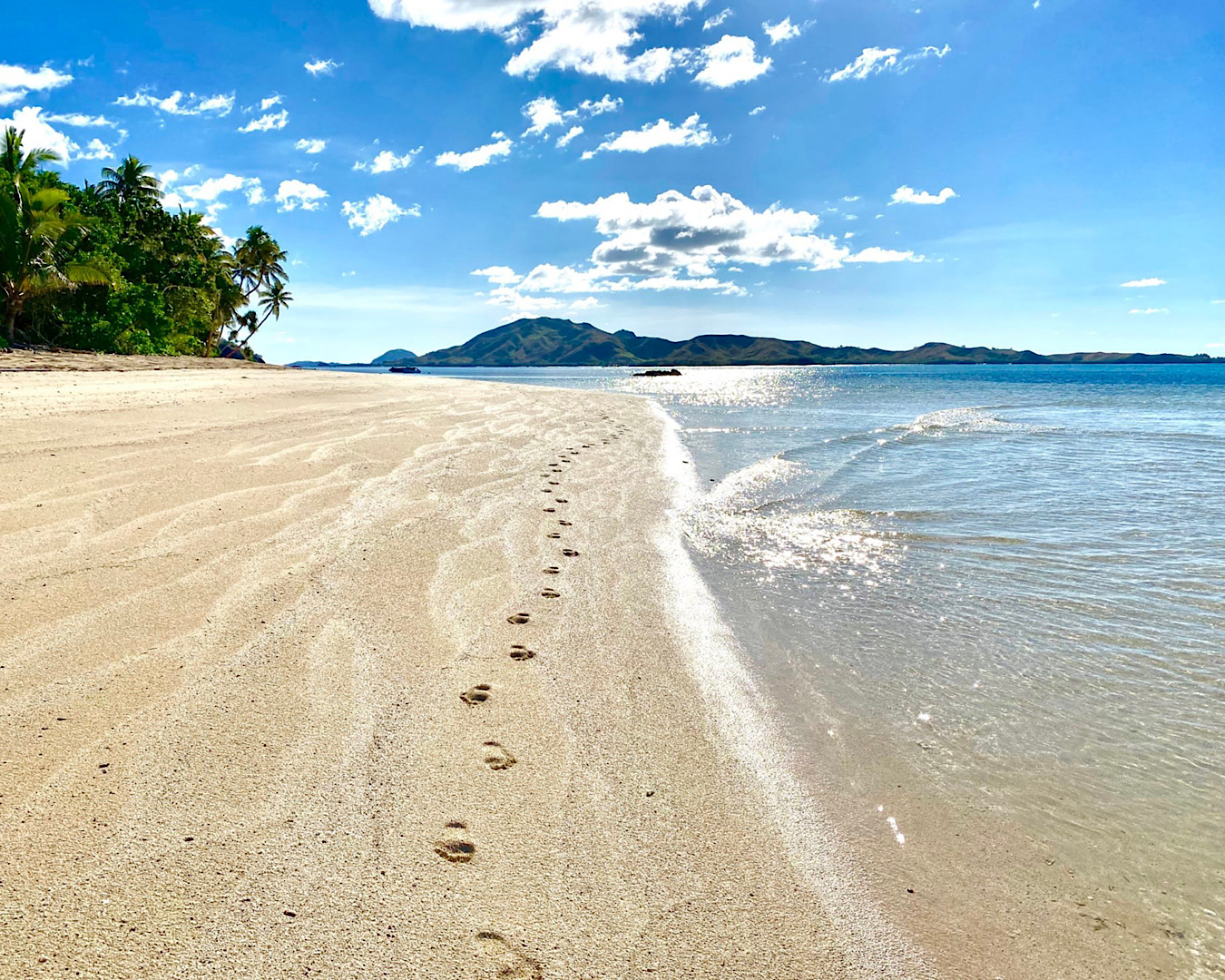 Footprints on the white sands of Coconut Beach Resort, one of the best resorts in Fiji. 
