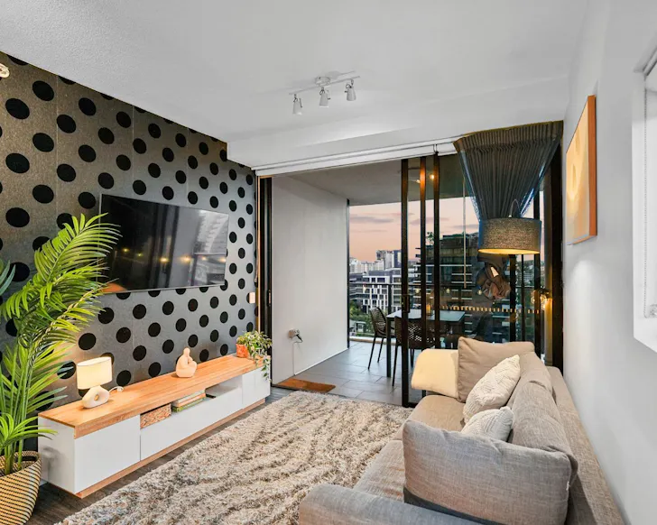 The lounge with its polkadot wall at Cola On Fish Lane best Brisbane Airbnbs