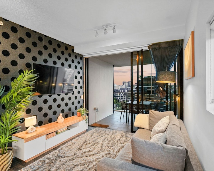 The lounge with its polkadot wall at Cola On Fish Lane best Brisbane Airbnbs