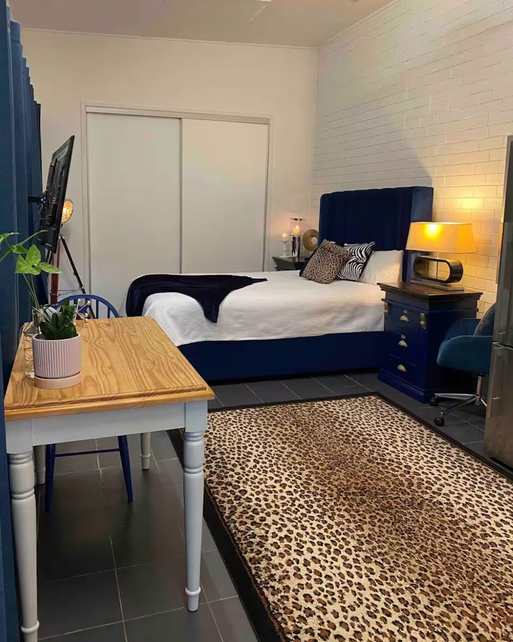 A view of the bed and leopard print rug at Comfy Guest House Airbnb one of the cheap accommodation options in Brisbane