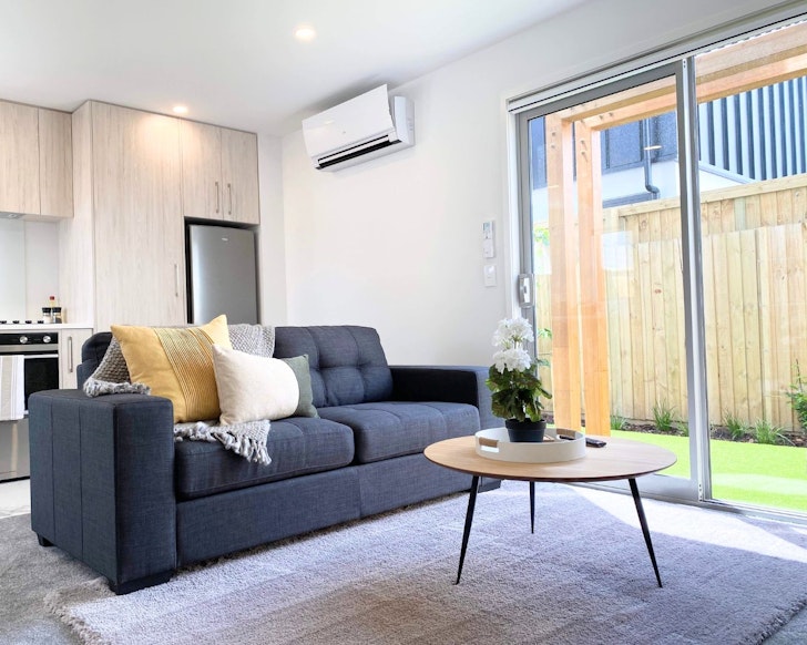 The lounge and backyard at Comfy Townhouse Apartment best Christchurch Airbnbs