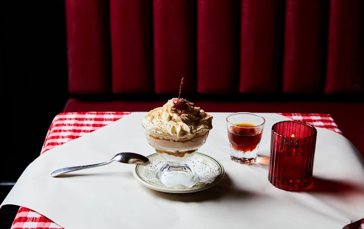A table set with a large sundae in the middle. 