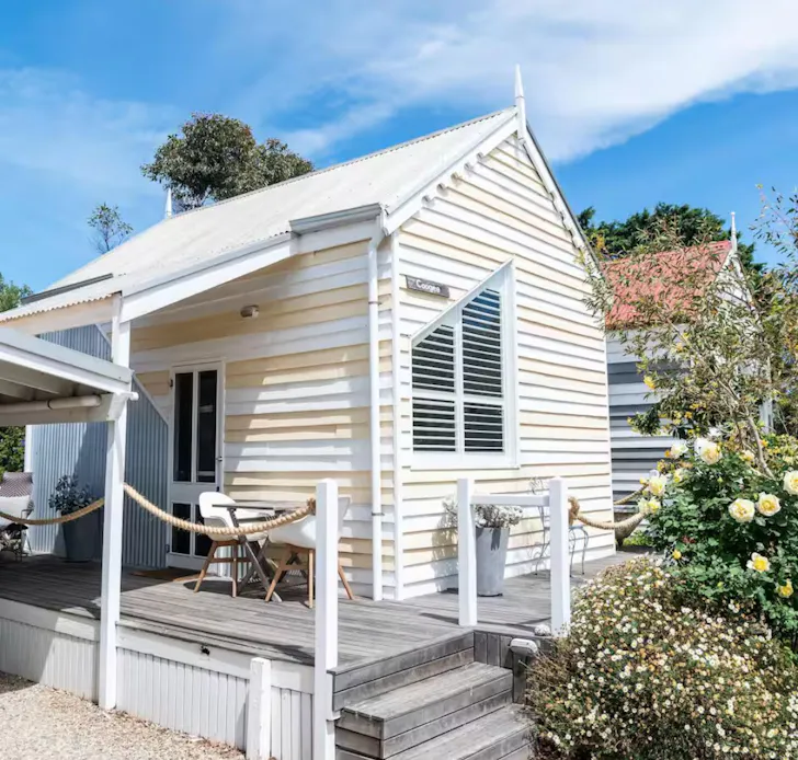 The lemon yellow and white exterior of Coogee Studio Hut one of the best Airbnbs in South Australia