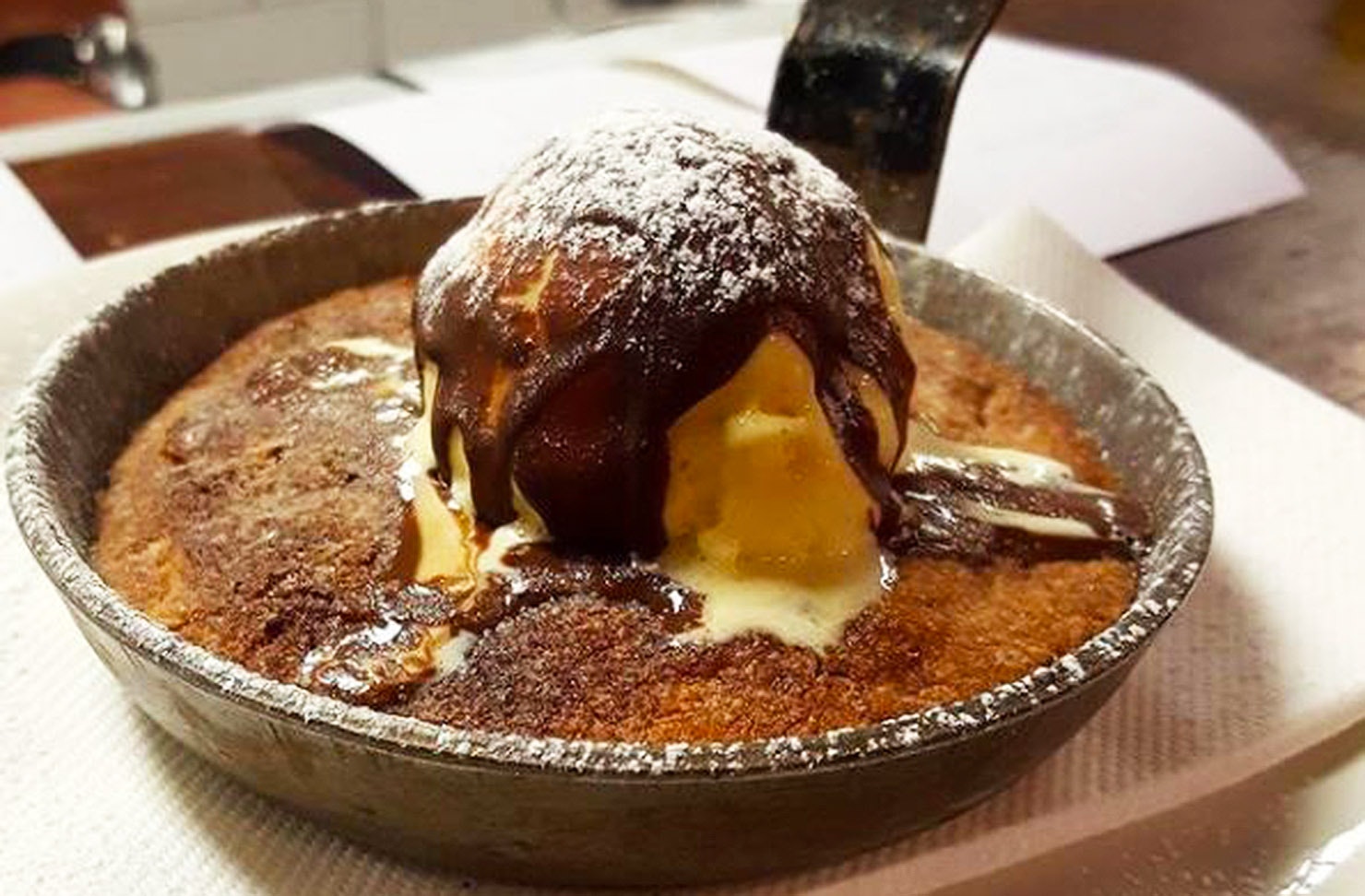 An up-close look at the skillet cookie at Depot, topped with ice cream, chocolate sauce, and all!