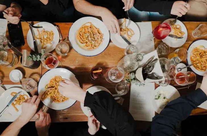 Diners eating pasta on a table at Pici Auckland