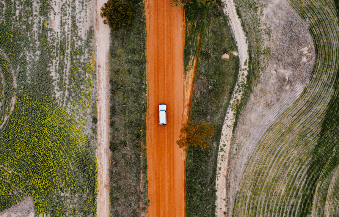 Aerial view of one car driving on a great southern outback road 