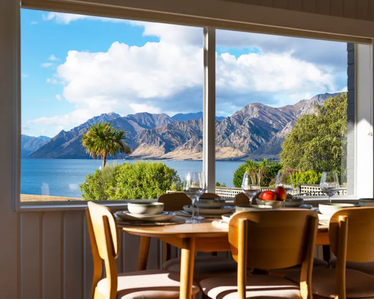 The lake view from a window at Corner Peak Cottage best lakefront Airbnbs NZ