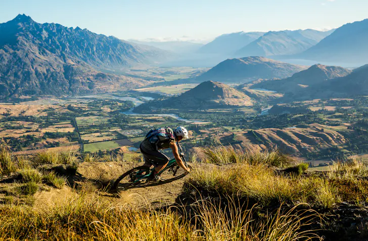 A person mountain biking at coronet peak