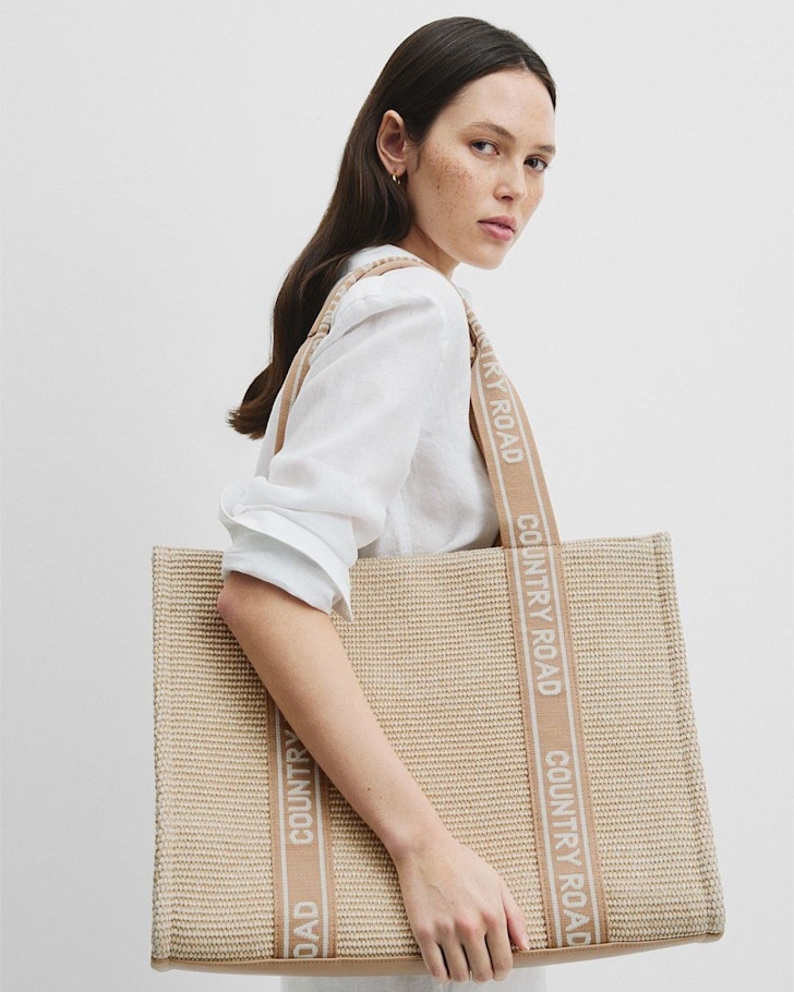 A woman models the Country Road Branded Tote one of the best gifts for her