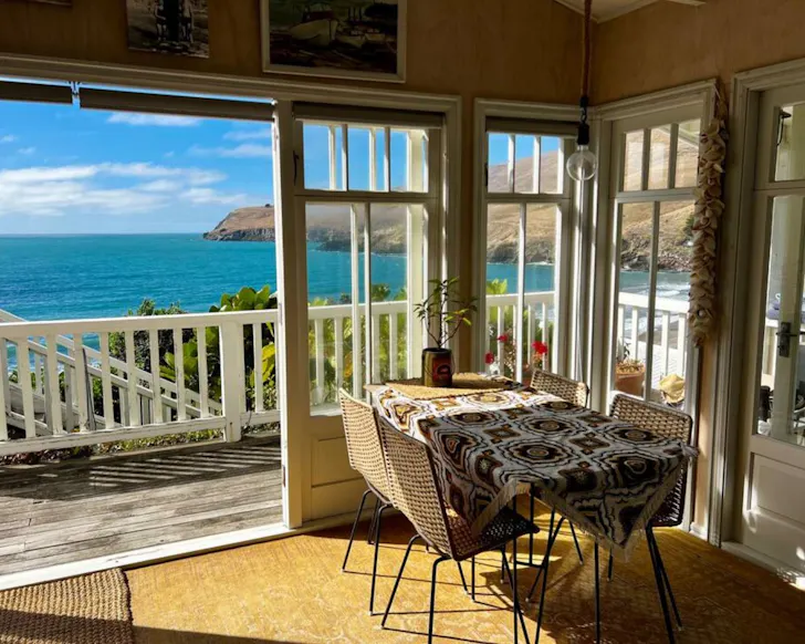 A view of the water from the living space at the Couples Beach Retreat romantic stay near Christchurch, New Zealand