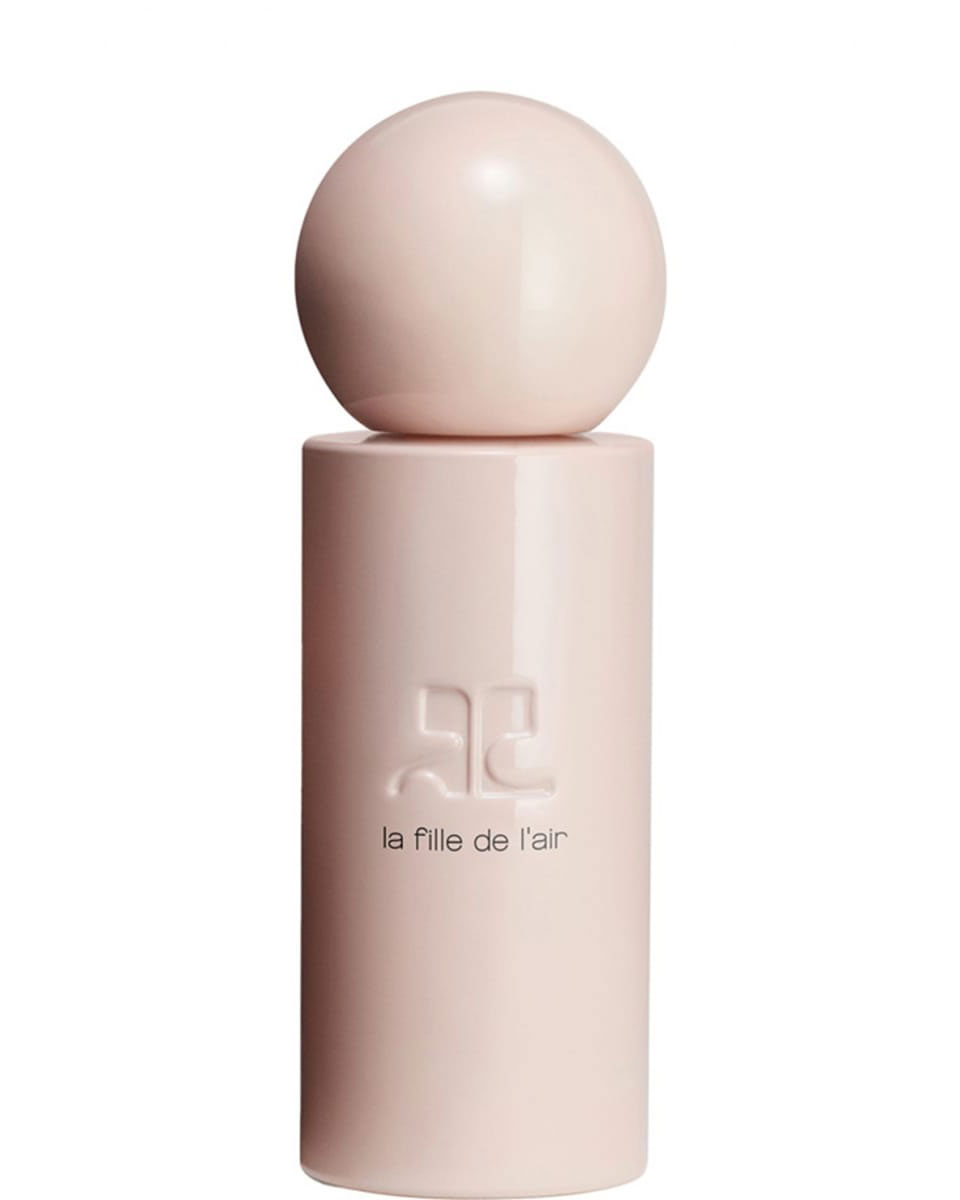 A tall, cylindrical, pastel pink bottle with a spherical lid and 'la fille de l'air' written on the bottle.