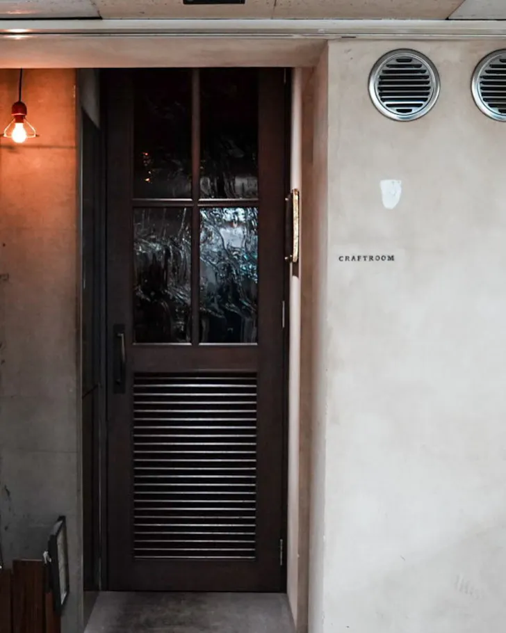 The unassuming, underground door of Craftroom in Osaka.