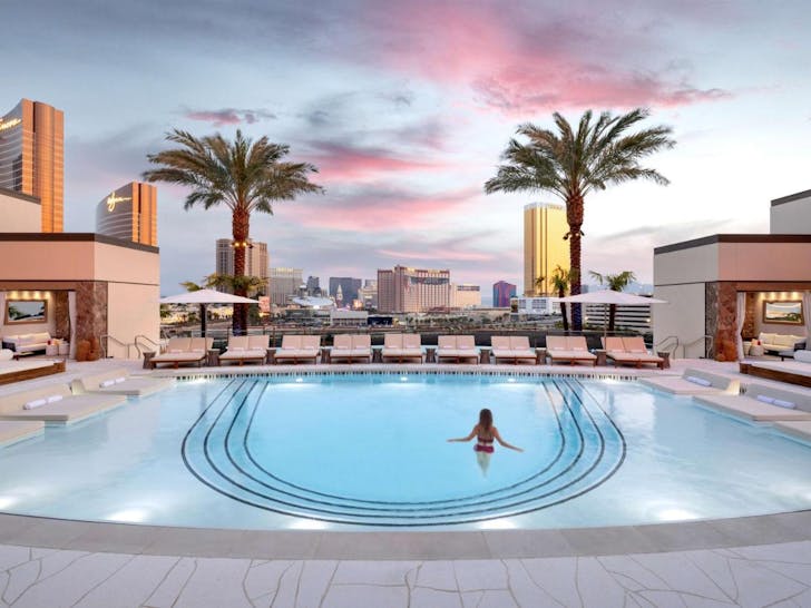 A guest enjoying the luxe outdoor pool at Crockfords, a Vegas hotel. 