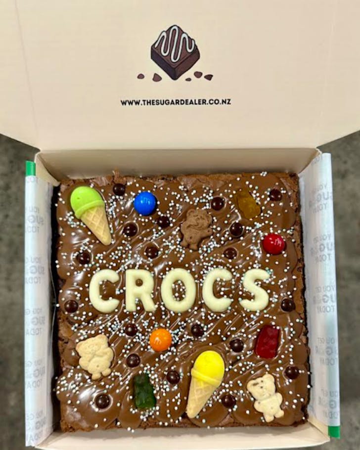 A boxed brownie by The Sugar Dealer with the word Croc on it. 