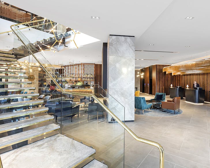 The impressive lobby at the Crowne Plaza shows golden railings amongst lots of space, no wonder it's one of the best hotels in Christchurch.