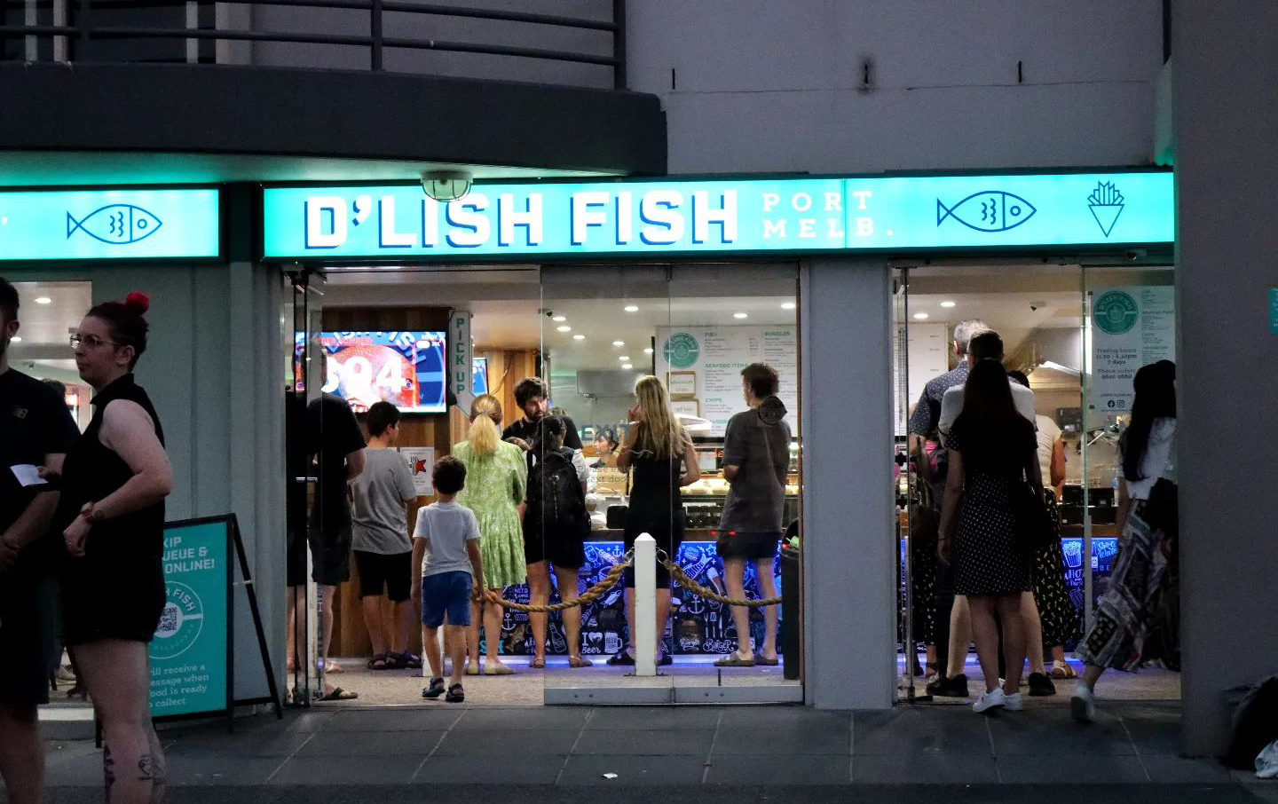 A fish and chips Melbourne shopfront with people lining up.