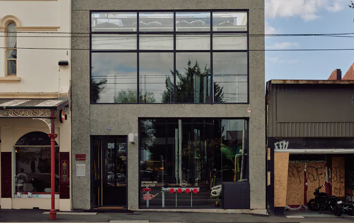 A simple concrete shopfront shot during the day from the street. 