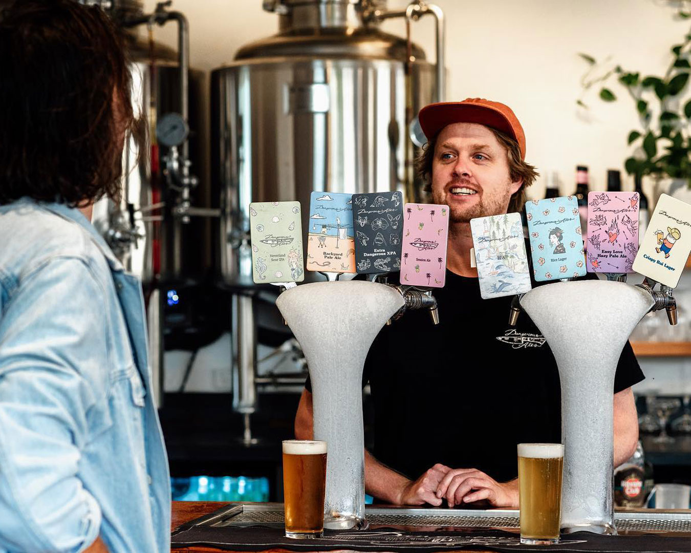 Bartender standing behind beer taps