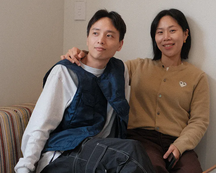 Dianne and Danny sit together in Parable House, smiling. 