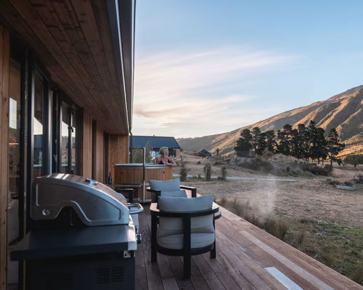 The outdoor space and hot tub with mountain view at Dark Skies Queenstown romantic Airbnb, New Zealand