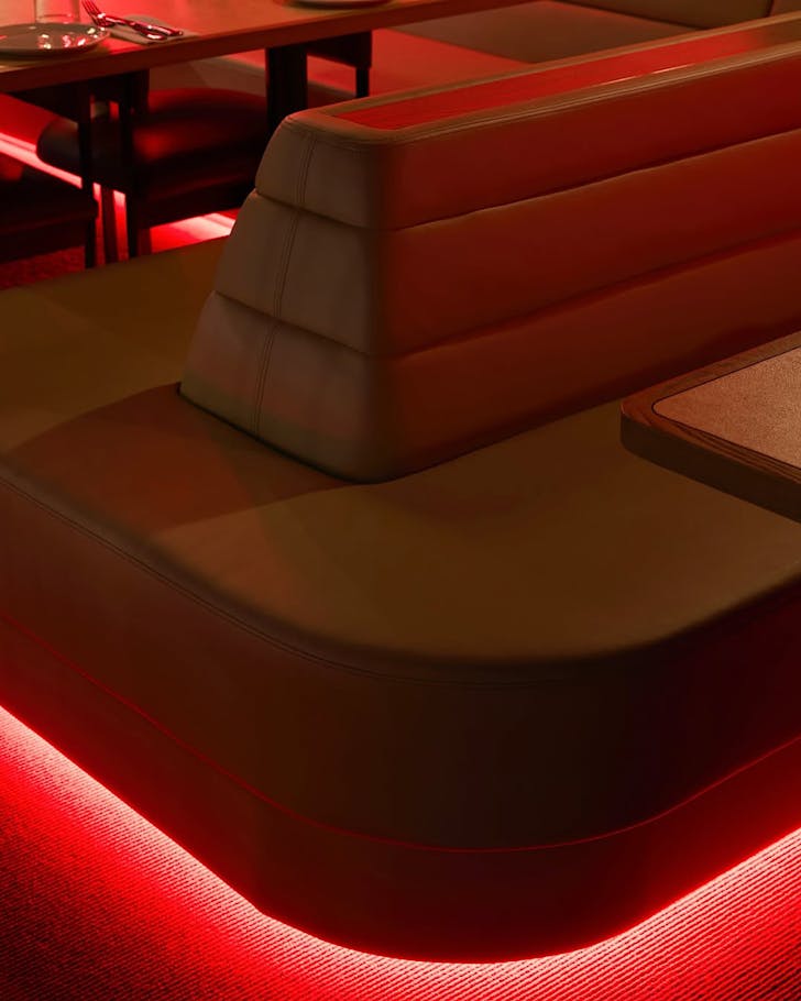 Almost vintage-style puff seating lit with neon red. 