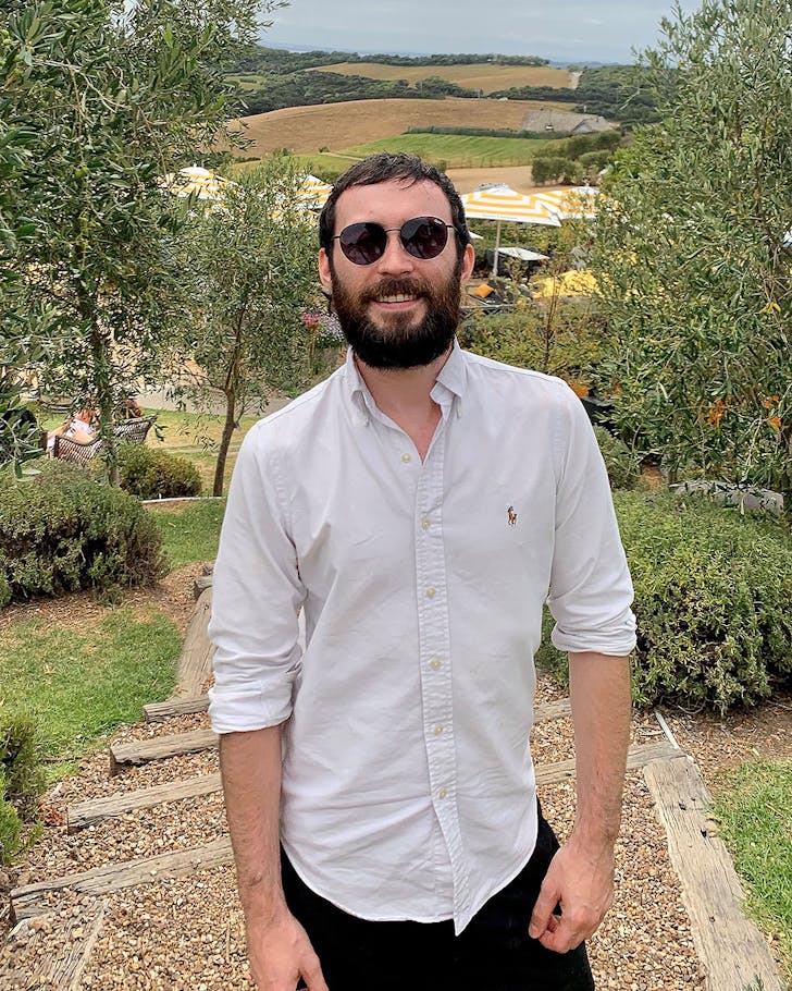 Darren from The Grill and Depot stands in an olive grove.
