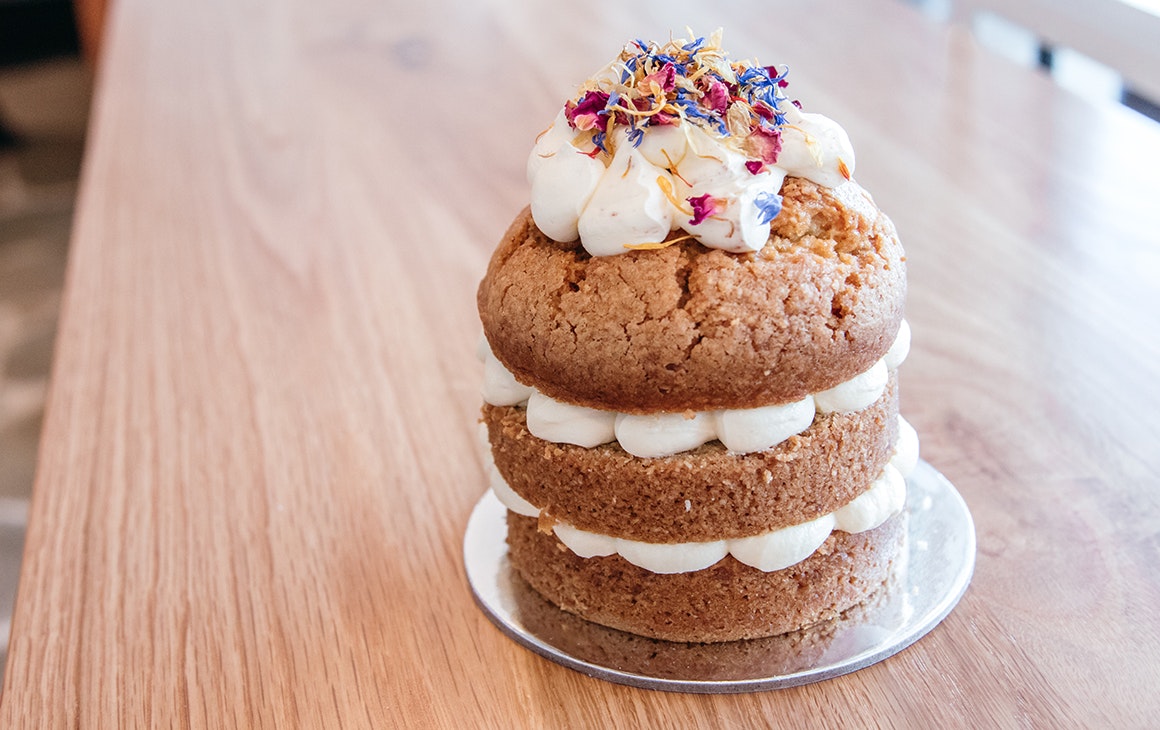 a mini cake with three layers and icing on top