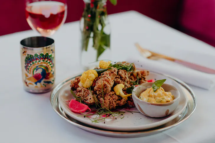 a plate of food and an ornate glass