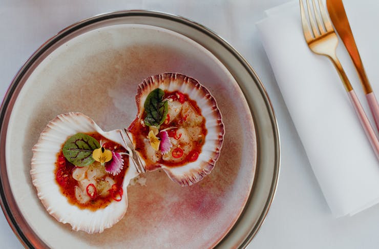 a pair of scallops on a plate