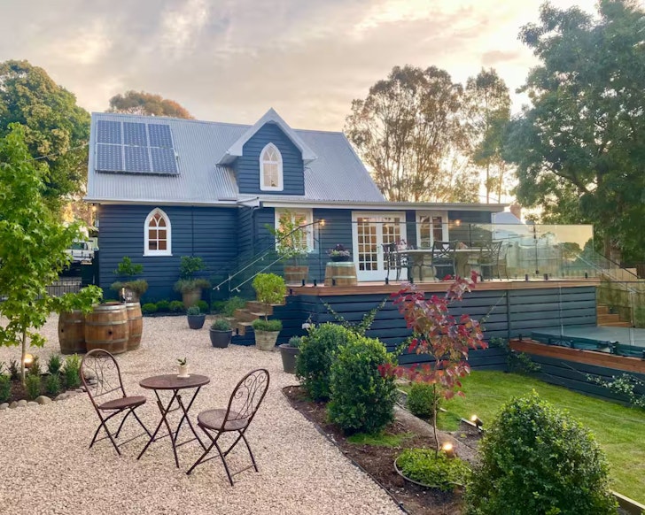 An exterior view of Daylesford Spa Haven Airbnb with its cathedral windows, one of the best accommodation options in Daylesford