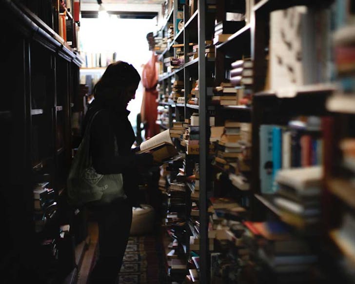 A customer leafs through one of the many hundreds of books at the Dead Soul's Bookshop. 