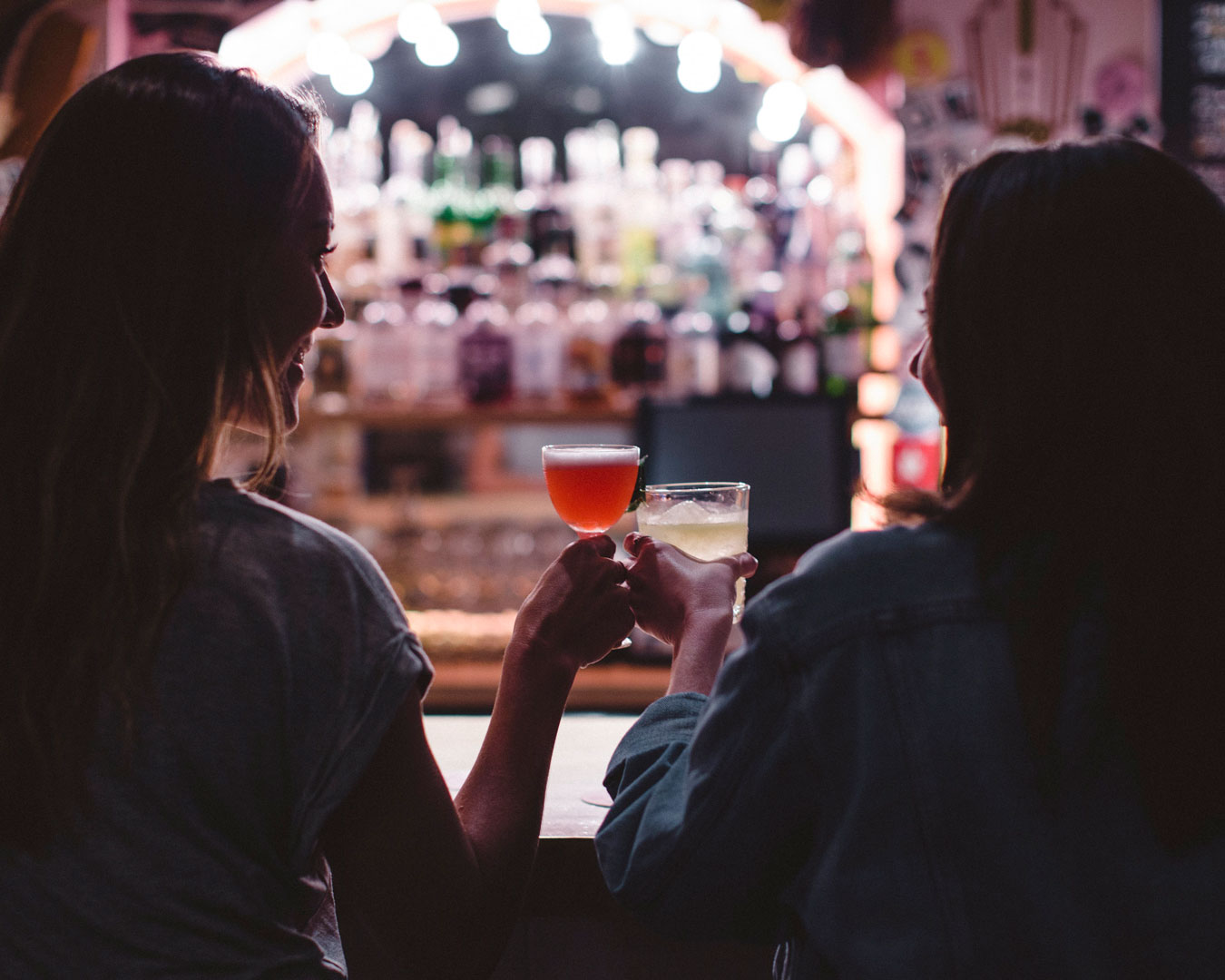 Women with cocktails at bar