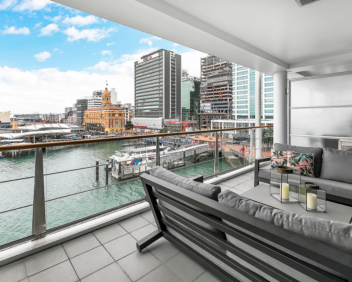 A covered outdoor deck looking over Auckland CBD and the buzzing harbour.