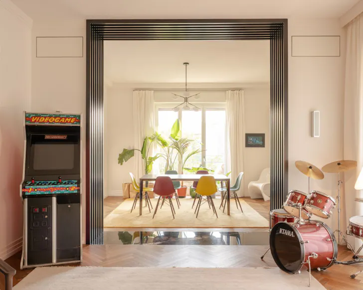 The living space with arcade game and drum kit at Design Apartment in City Centre best Milan Airbnbs