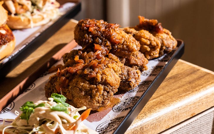 A plate of the best fried chicken Melbourne with a chutney on top. 